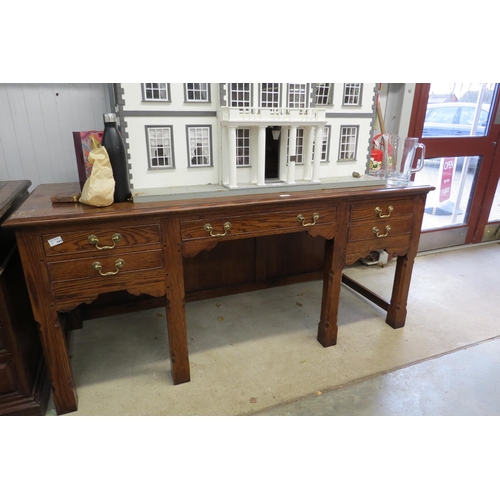 2063 - A reproduction Georgian oak desk, with five frieze drawers, on chamfered square legs, brass swan nec... 