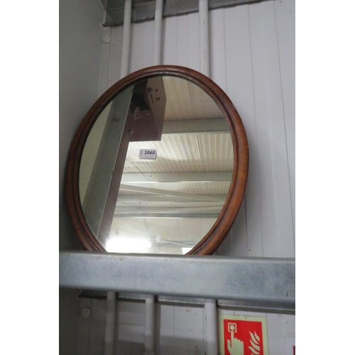 2068 - A 19th Century mahogany oval wall mirror with slightly speckled mirror plate  40 x 50cm