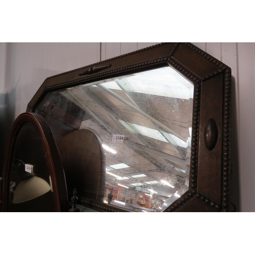 2104 - An Edwardian oak framed wall mirror with well worn mirror plate     (R) £20