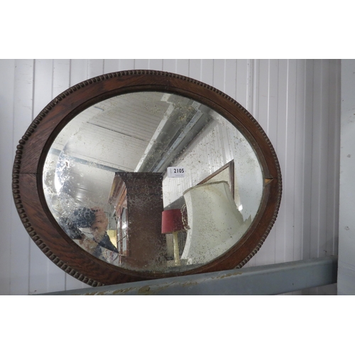 2105 - An Edwardian oak framed wall mirror with well worn mirror plate     (R) £20