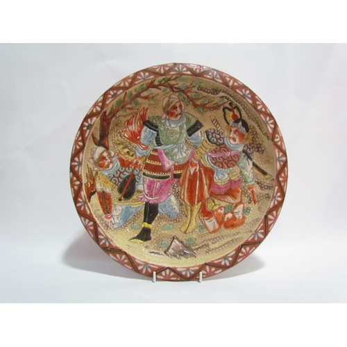 4292 - An Oriental wall charger with scene depicting warriors, 34cm wide