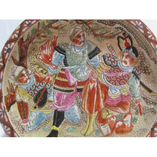 4292 - An Oriental wall charger with scene depicting warriors, 34cm wide