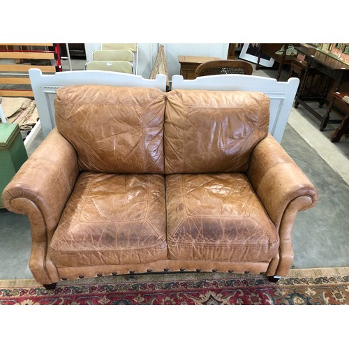 2299 - A nicely worn tan leather two seater cottage sofa      (R) £150