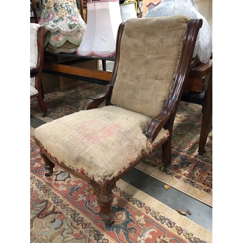 2332 - A Victorian mahogany framed fireside chair for covering