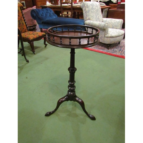 4004 - A George III mahogany circular top wine table the turned spindle raised gallery over a turned and wr... 