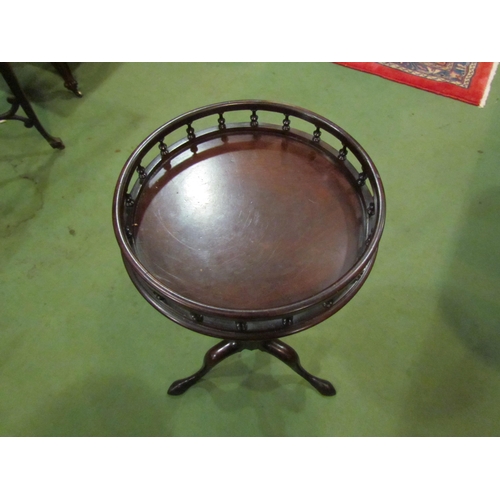 4004 - A George III mahogany circular top wine table the turned spindle raised gallery over a turned and wr... 