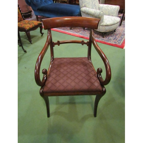 4017 - A Circa 1830 mahogany scroll arm elbow chair with carved bar back rest over sabre legs