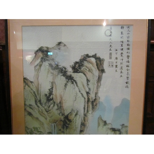 4222 - An Oriental silk picture, mountain, trees middle ground, figures on bridge by river, framed and glaz... 