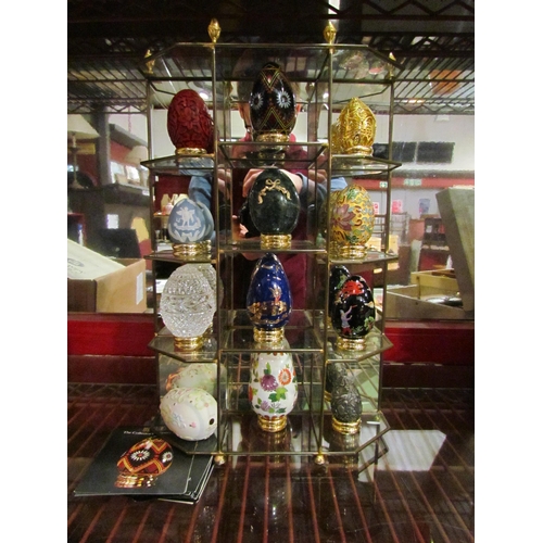 4481 - A brass mirror backed table top collectors unit by Franklin Mint and a collection of treasury eggs t... 