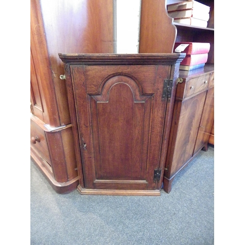 1018 - A 19th Century oak corner cupboard with panelled door, shelved interior, missing moulding, 87cm tall... 