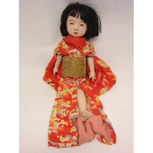 1222 - A mid 20 Century composition Japanese character doll, stuffed cloth body with composition limbs, wea... 