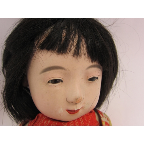 1222 - A mid 20 Century composition Japanese character doll, stuffed cloth body with composition limbs, wea... 