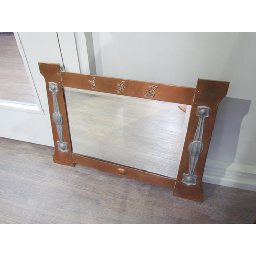 1088 - An Arts and Crafts copper wall mirror, the top rail with 'E.G.H.' lettering, the sides with inset pe... 