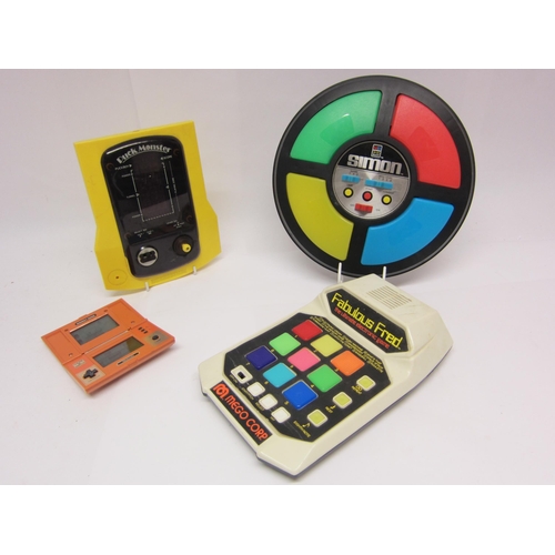 1244 - A group of four early 1980's handheld and table top electronic games to include Mego Corp Fabulous F... 