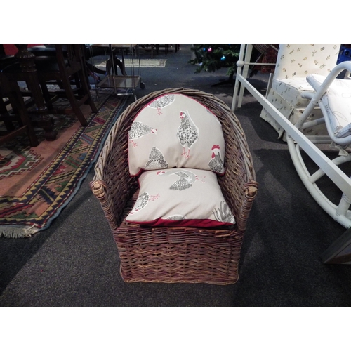 1099 - A wicker child's chair and two cushions