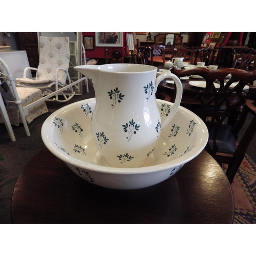 1106 - A wash jug and bowl set, cream ground with floral detailing   (D)