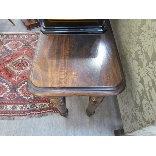 1128 - A reproduction mahogany console table, round-cornered top over turned supports, 86cm tall x 157cm lo... 