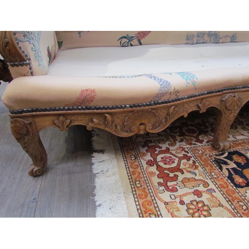 1154 - A Louis XV style hump-back sofa, carved scrolled foliate frame with scroll feet, bespoke floral and ... 