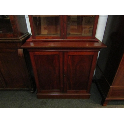 1132 - A mid Victorian flame mahogany two door cupboard with key on a plinth base, 98cm tall x 92cm wide x ... 