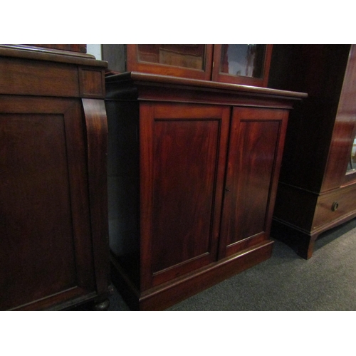 1132 - A mid Victorian flame mahogany two door cupboard with key on a plinth base, 98cm tall x 92cm wide x ... 