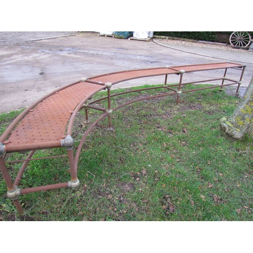 3268 - A brass and steel curved bench a/f, approx 17' long