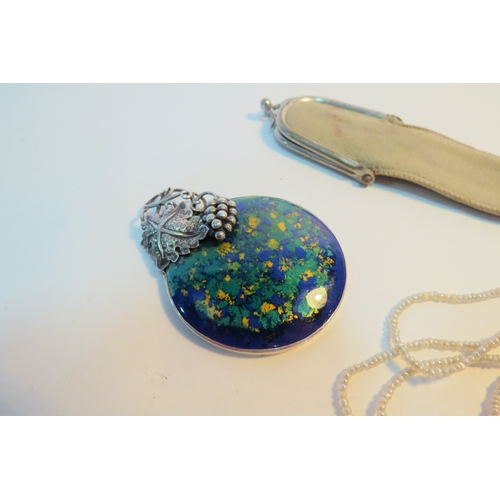 1274 - An enamel sterling silver handbag/pendant mirror, string of seed pearls (no clasp) and a suede pouch... 