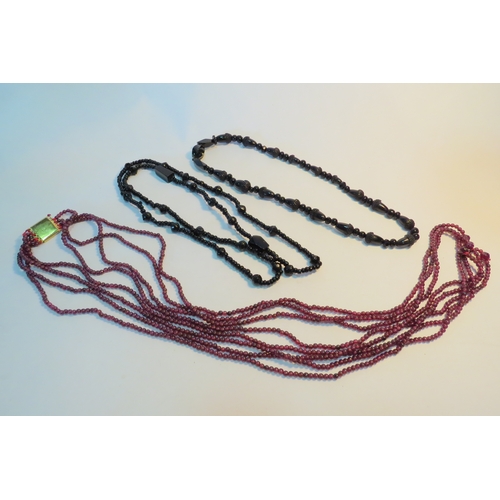 1276 - A four row garnet bead necklace and two jet necklaces (C)