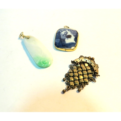 1294 - A jade pendant, pottery fragment pendant and miniature chain purse