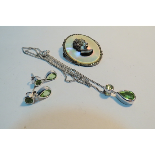 1301 - A pendant hung on chain stamped 925 and a pair of matching earrings, with a cameo brooch