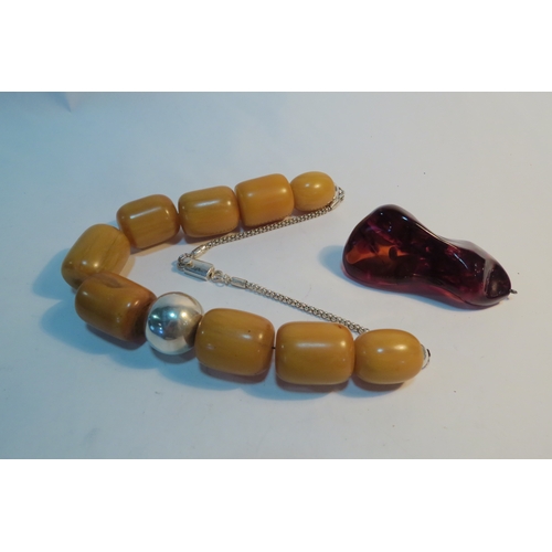 1313 - A large amber pendant and a costume bead necklace  (C)