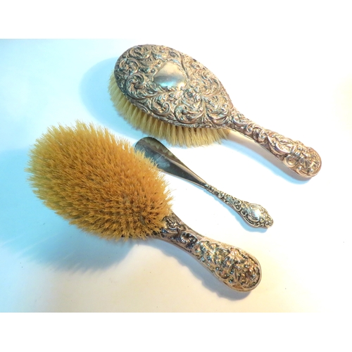 1347 - Two silver backed hairbrushes and a silver handled shoe horn   (E) £20-30