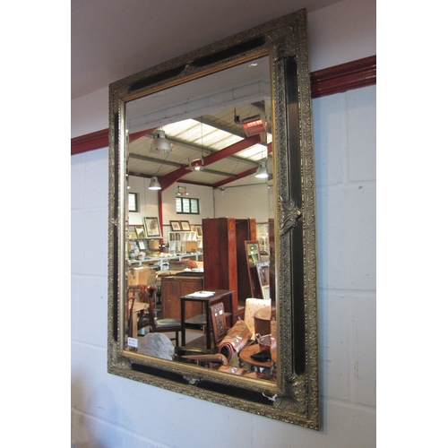 1009 - A classical style modern wall mirror of rectangular form, gilt and ebonised, 91cm x 66.5cm