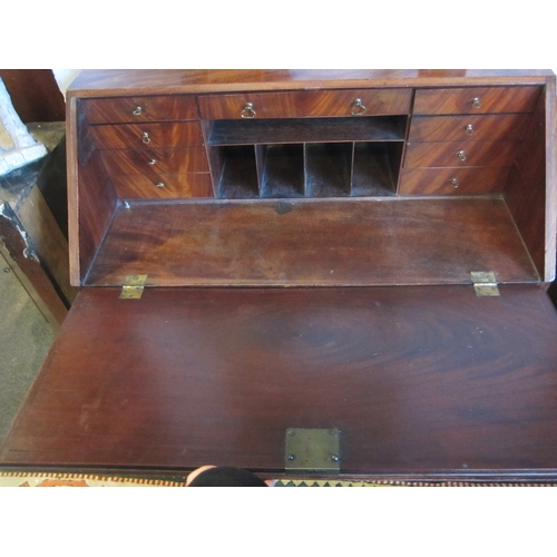 1016 - An early Victorian flame mahogany bureau, the fall front over four graduated drawers, bun handles, b... 