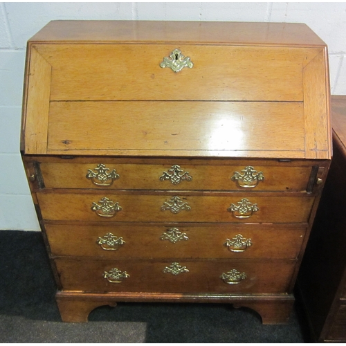 1033 - A Georgian oak bureau, the fall front over four graduating long drawers, bracket feet, some losses, ... 