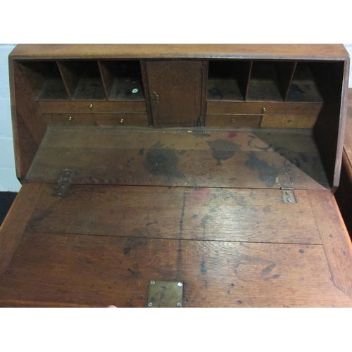 1033 - A Georgian oak bureau, the fall front over four graduating long drawers, bracket feet, some losses, ... 