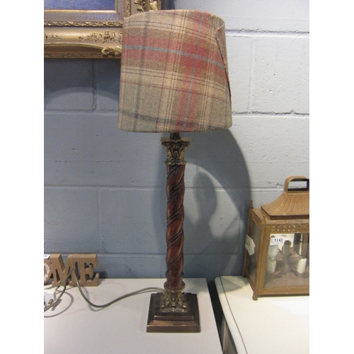 1082 - A hardwood table lamp base of ropetwist column form, brass cornithian mounts, tartan shade