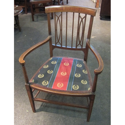 1090 - An Edwardian mahogany elbow chair, crossbanded detail, shaped pierced back, upholstered seat, on tur... 