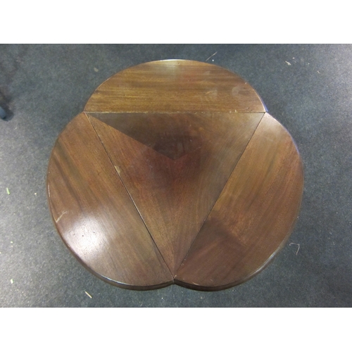 1091 - An Edwardian mahogany cloverleaf occasional table with folding leaves, on ring-turned supports, outs... 