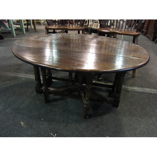 1102 - An oak gateleg coffee table, 95cm diameter