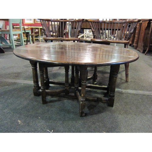 1102 - An oak gateleg coffee table, 95cm diameter