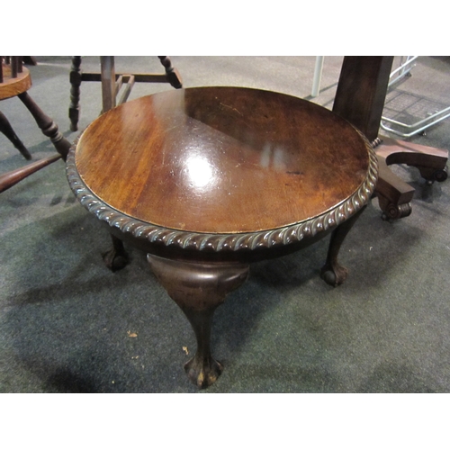 1104 - A 1930's walnut circular coffee table with piecrust top, on ball and claw cabriole legs, 59cm diamet... 