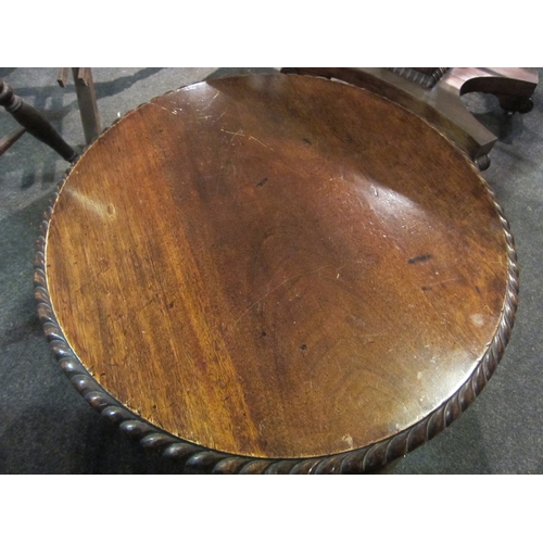 1104 - A 1930's walnut circular coffee table with piecrust top, on ball and claw cabriole legs, 59cm diamet... 