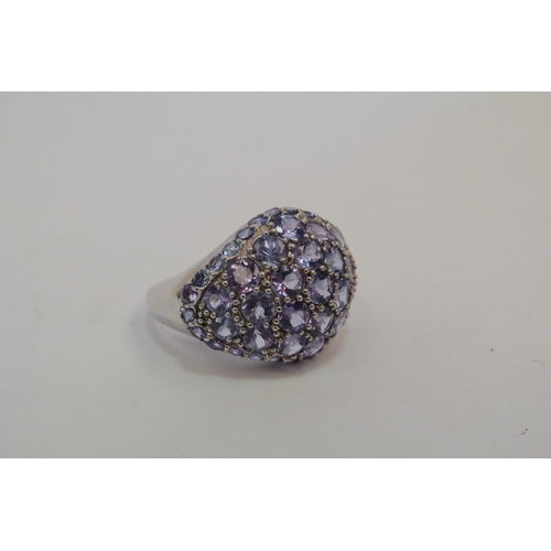 1119 - A 9ct white gold tanzanite cluster ring, 6g