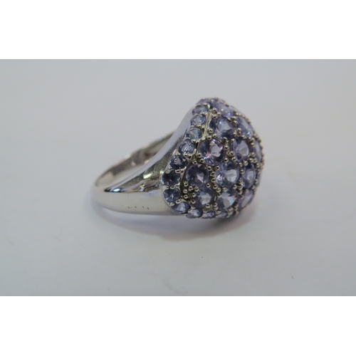 1119 - A 9ct white gold tanzanite cluster ring, 6g