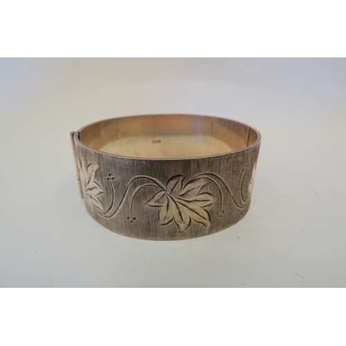 1232 - A silver foliate engraved bangle, Birmingham 1975, 55g  (R)  £20