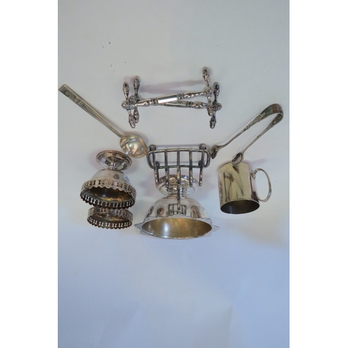 1359 - A selection of plated items including toast rack, mug, knife rests, sugar tongs etc.   (C)