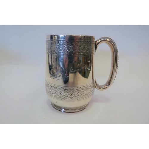 1363 - A silver mug with engraved bands, inscribed 