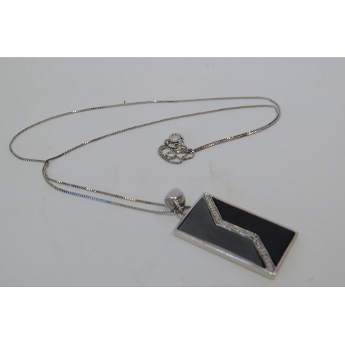 1406 - A 9ct white gold onyx and diamond set rectangular pendant on chain, 6g