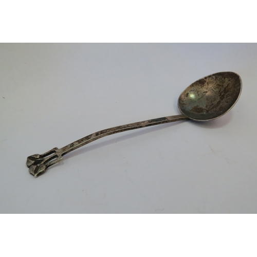 1306 - An A.E.Jones silver preserve spoon, planished decoration, Birmingham 1910