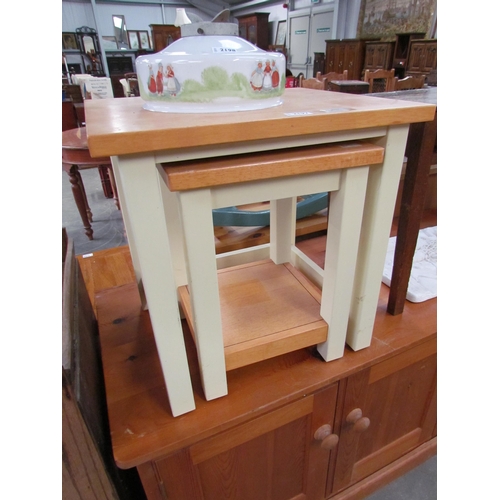 2197 - A nest of two hardwood occasional tables with cream painted bases